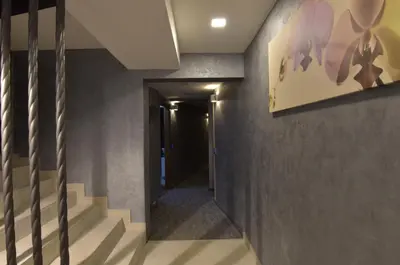 a hallway with stairs and a painting on the wall at Apartman Jelač Konaci in Kopaonik