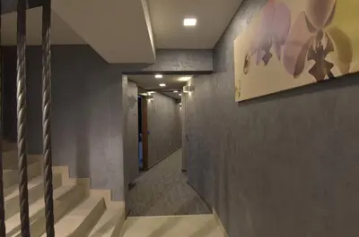 a hallway with stairs and a painting on the wall at Apartman Jelač Konaci in Kopaonik