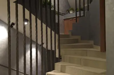 a set of stairs with a black railing at Apartman Jelač Konaci in Kopaonik