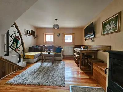 a living room with a couch and a table at Dajoda free spa in Kopaonik
