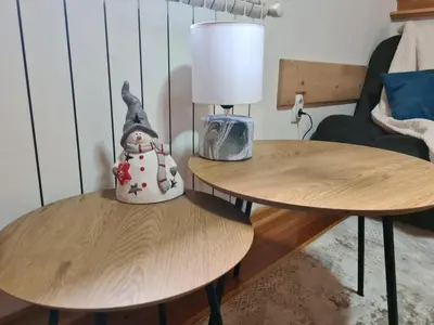a lamp on two tables in a living room at Dajoda free spa in Kopaonik