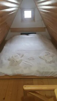 a bed in a wooden room with towels on it at Dajoda free spa in Kopaonik