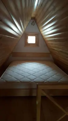 a small bed in a small room with a window at Dajoda free spa in Kopaonik