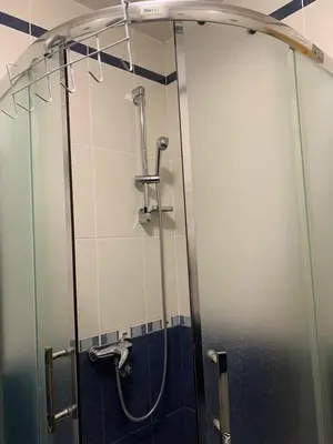a shower in a bathroom with a glass door at Apartmani Mićić in Vrnjačka Banja