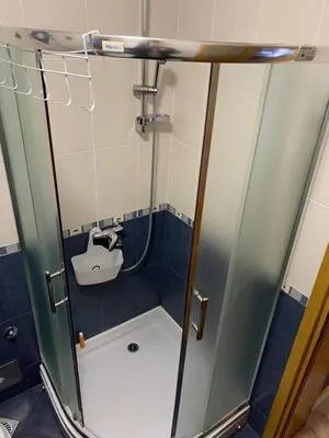 a shower in a bathroom with a sink at Apartmani Mićić in Vrnjačka Banja