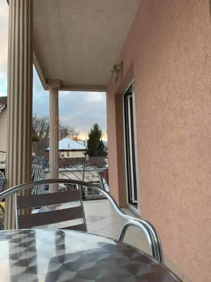 a balcony with a table and chairs on a patio at Apartmani Mićić in Vrnjačka Banja