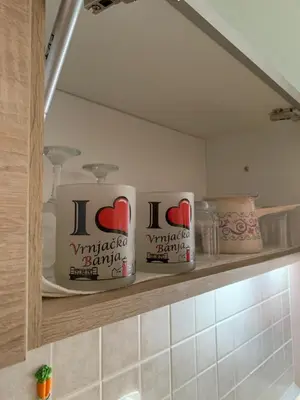 a shelf in a kitchen with two canisters on it at Apartmani Mićić in Vrnjačka Banja