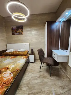 a bedroom with a bed and a desk and a chair at Ebra Kraljevi Čardaci Kopaonik in Kopaonik