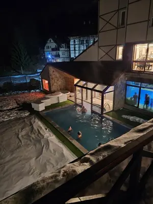 two people in a swimming pool at night at Ebra Kraljevi Čardaci Kopaonik in Kopaonik