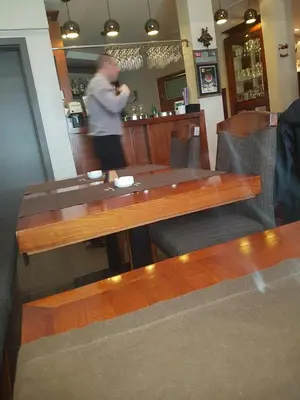 a man standing behind a table in a bar at Ebra Kraljevi Čardaci Kopaonik in Kopaonik