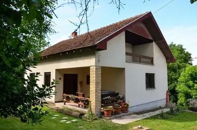 a white house with a red roof at Kuca za odmor Radovanovic in Despotovac