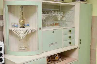 a cabinet filled with glasses and other items at Kuca za odmor Radovanovic in Despotovac