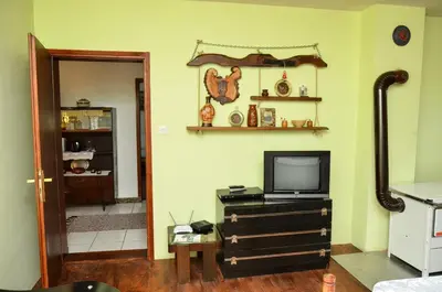 a living room with a tv on a dresser with a television at Kuca za odmor Radovanovic in Despotovac