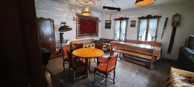 a living room with a table and a piano at Golemi kamik Pirot in Pirot
