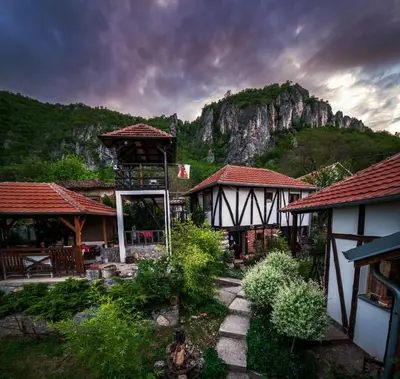 a group of houses with a mountain in the background at Golemi kamik Pirot in Pirot
