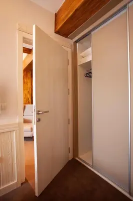 a room with a sliding door and a bedroom at Zupa Deluxe Kopaonik in Kopaonik