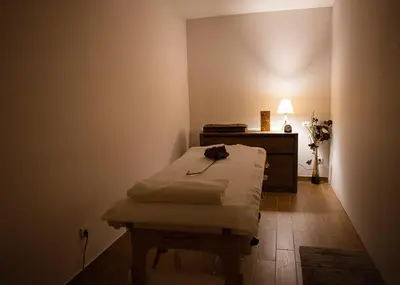 a small room with a bed and a desk with a lamp at Zupa Deluxe Kopaonik in Kopaonik