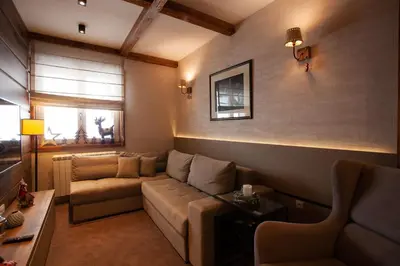 a living room with a couch and a table at Zupa Deluxe Kopaonik in Kopaonik