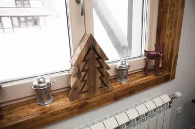 a wooden christmas tree on a window sill at Zupa Deluxe Kopaonik in Kopaonik