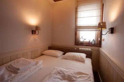 a room with a bed with two pillows and a window at Zupa Deluxe Kopaonik in Kopaonik