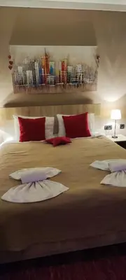a bedroom with a large bed with red and white pillows at Apartman Sunset Milmari Kopaonik M10 in Kopaonik