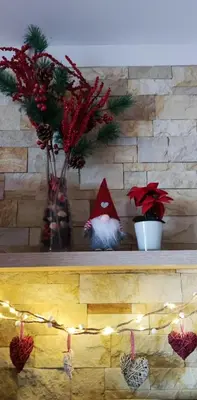 a shelf with christmas decorations on it with candles at Apartman Sunset Milmari Kopaonik M10 in Kopaonik