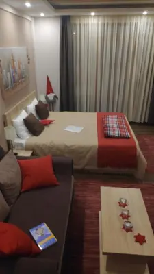 a living room with two beds and a couch at Apartman Sunset Milmari Kopaonik M10 in Kopaonik