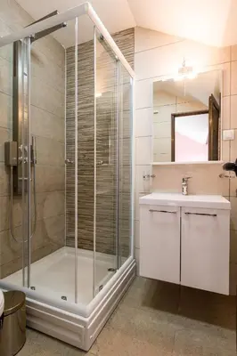 a bathroom with a shower and a sink at Prenoćište HRAST in Paraćin