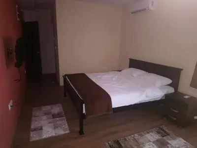 a bedroom with a bed with white sheets and pillows at Prenoćište HRAST in Paraćin