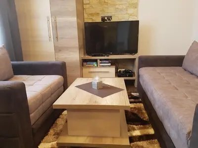 a living room with two couches and a tv at Apartment M1 MEGI, Milmari Resort in Kopaonik
