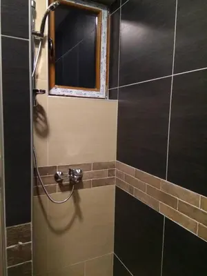 a bathroom with a shower with a mirror and a window at Apartment M1 MEGI, Milmari Resort in Kopaonik