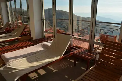 a balcony with beds and chairs on a ship at Apartment M1 MEGI, Milmari Resort in Kopaonik