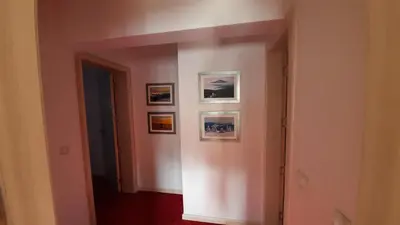 a hallway with three pictures on the wall at Apartmani ŽUPA in Kopaonik