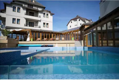a large swimming pool in front of a building at Katia М14 Milmari Resort in Kopaonik