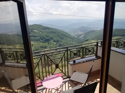 a balcony with chairs and a view of mountains at Katia М14 Milmari Resort in Kopaonik