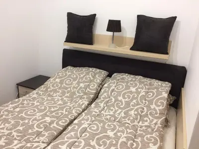 a bed with two pillows on top of it at Apartment Lazic vila Suri in Kopaonik
