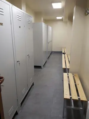 a row of lockers and benches in a locker room at Apartment Lazic vila Suri in Kopaonik