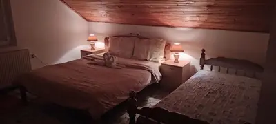 a bedroom with a bed with two lamps on it at Sanja Accomodation in Soko Banja