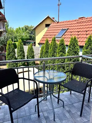 a table and two chairs on a balcony at Vila Markovic-a in Soko Banja