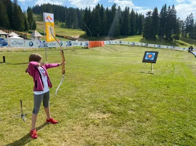 a young girl holding a kite in a field at Milmari M18 Kopaonik in Kopaonik