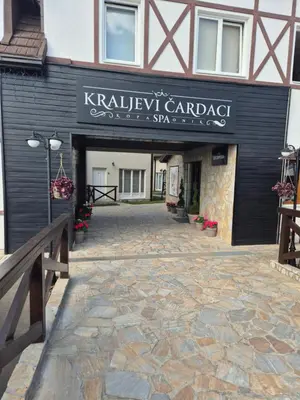 a building with a sign that reads kalameway carapace garage starbucks at kraljevski apartman in Kopaonik