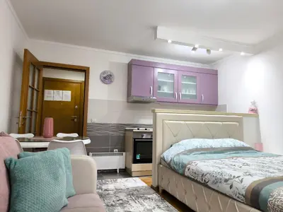 a bedroom with purple cabinets and a bed at Alex 2 apartman in Vrnjačka Banja
