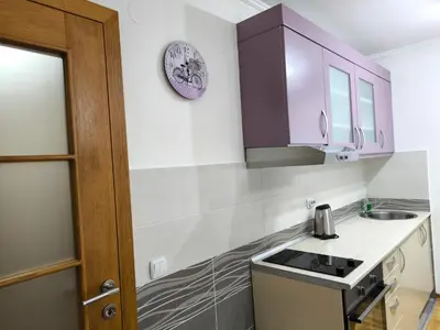a kitchen with purple cabinets and a sink at Alex 2 apartman in Vrnjačka Banja