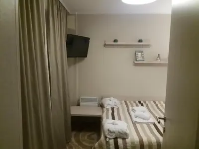 a room with a bed with towels on it at Exclusive Apartment B7 Milmari Resort in Kopaonik