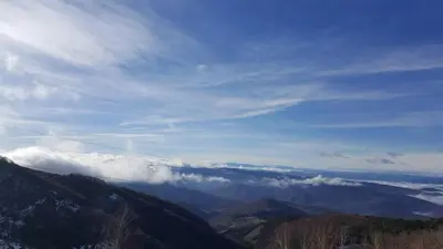 a view of a mountain range with clouds in the sky at Apartment Simonida - Milmari M3 in Kopaonik