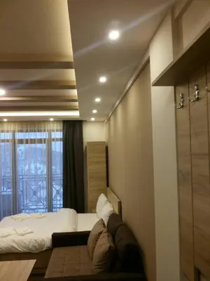 a bedroom with a bed and a large window at Apartment Simonida - Milmari M3 in Kopaonik