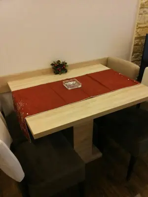 a wooden table with a napkin on top of it at Apartment Simonida - Milmari M3 in Kopaonik