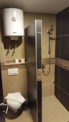 a bathroom with a shower with a toilet and a sink at Apartment Simonida - Milmari M3 in Kopaonik