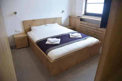a bedroom with a bed with two towels on it at Apartment Mint in Kopaonik