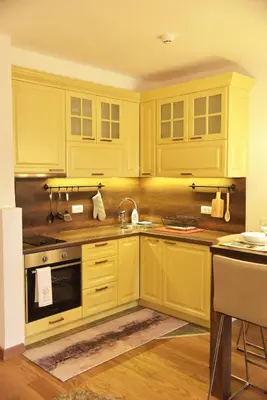 a kitchen with yellow cabinets and a sink at Apartment Mint in Kopaonik